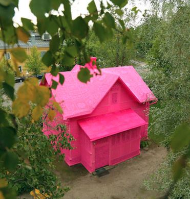 Yes, that's a house covered in Red Heart Yarn (by artist Olek). redheart